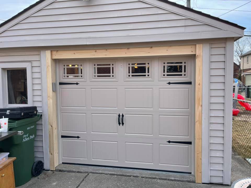 Carriage garage door with black handles and hinges 