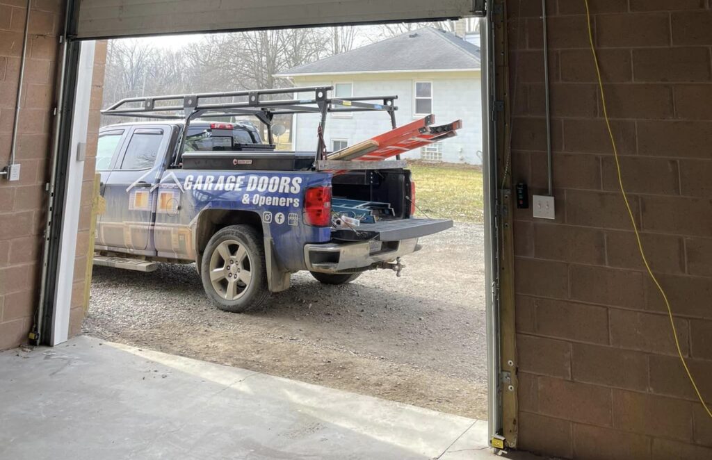 View of The Garage Door Guy service vehicle from inside of a garage after a garage door repair