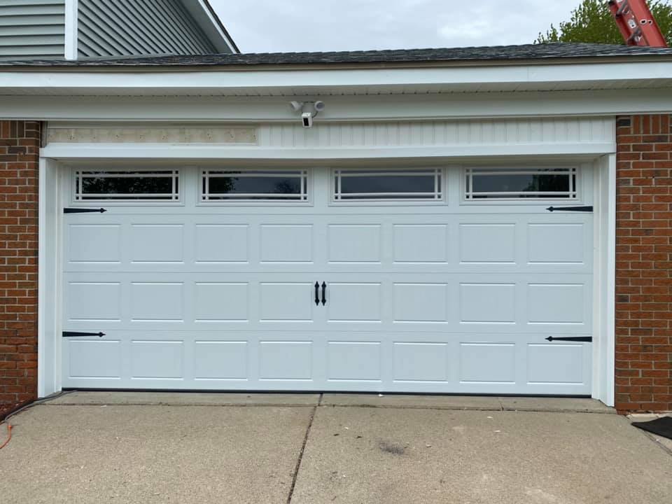new white traditional garage door with windows
