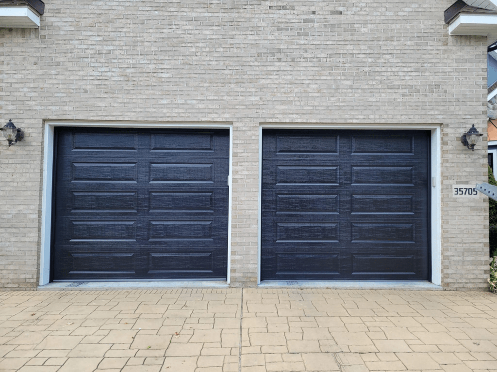 new black traditional garage doors with long panels